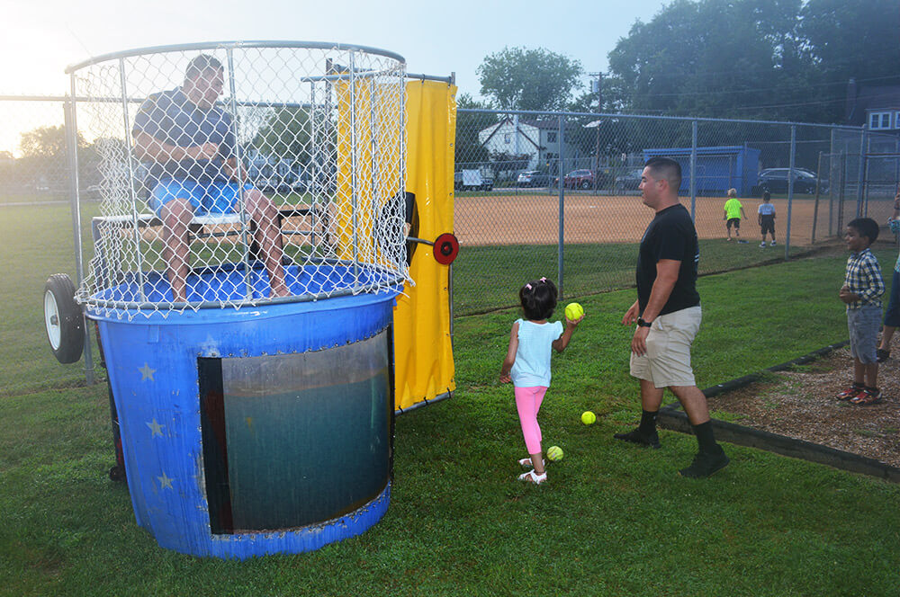 Officer in dunk tank with community members